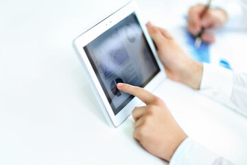 business man with a digital tablet analyzing a financial chart.