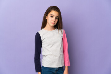 Little girl isolated on purple background with sad expression