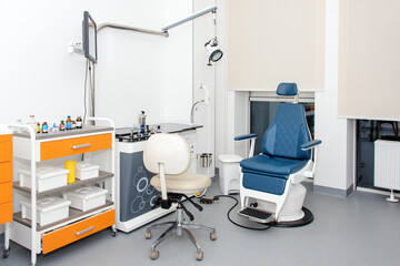 Modern dental practice. Dental chair and other accessories used by dentists. Dentist Office, Dental Hygiene. Colorful interior of dentistry office with chair and tools.