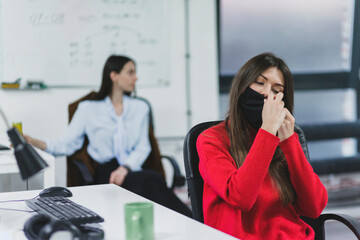 Woman adjusting face mask in office