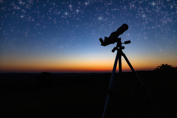 Silhouette of a astronomy telescope with twilight sky.