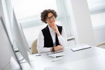 Portrait of a business woman with glasses at workplace in office