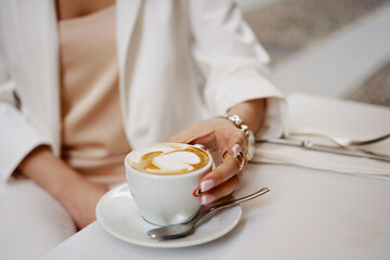 Coffee in a Cup. Hand with a Cup of coffee