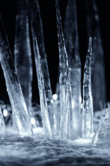 Naklejka na ściany i meble crystal icicles in snow at dark night