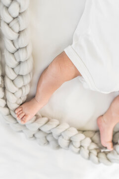 Baby feet and legs on bed 
