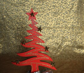painted wooden Christmas decoration, spruce on elegant golden background - christmas card