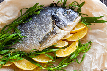 Diet sea dorado fish prepared for baking with lemon and herbs