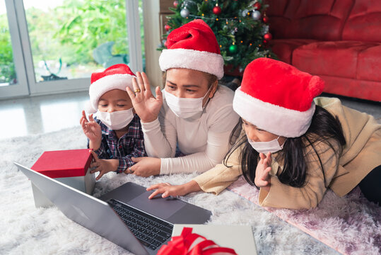 the family wearing the protective mask and video calls during the Christmas festival celebration.