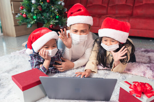 the family wearing the protective mask and video calls during the Christmas festival celebration.
