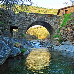 Medieval stone bridge over the river Hurdano in Casarrubia village. Las Hurdes is a mountanious region of the north of Caceres province, Extremadura, Spain