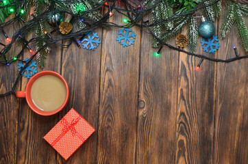 Christmas background with copy space text wooden decoration  and glowing garlands on wooden table top view