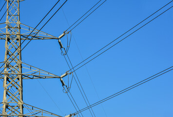 Tower structure High voltage pole tower on blue sky background.