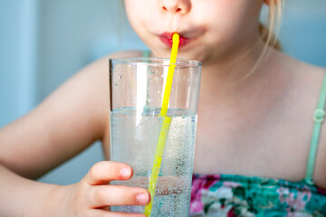 Little girl drinking a fresh glass of water
