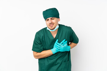 Surgeon in green uniform isolated on isolated white background having a pain in the heart