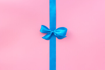Blue ribbon with bow for holiday gift box or greeting card banner. Top view