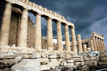 View of the archaeological site of Acropolis with ancient stones and Parthenon temple in the background - Athens, Greece, February 5 2020.