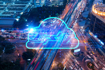 Storage cloud hologram on top view of road, busy urban traffic highway at night. Junction network of transportation infrastructure. The concept storing digital information. Double exposure.