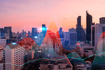 Glowing FOREX graph hologram, aerial panoramic cityscape of Bangkok at sunset. Stock and bond...
