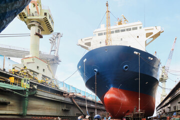 Shipyard The bulk carrier general cargo ship in dry dock yard, navigation bridge deck, recondition...