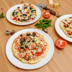 Homemade pizza with tomatoes on wooden table