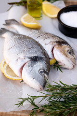 Raw Dorado fish with lemon, salt, rosemary and olive oil.