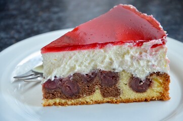 Homemade snow white cake (in other parts of the country called Little red riding hood cake) with chocolate, cherries and cream filling, red cherry juice glaze,a sweet speciality in Germany and Austria