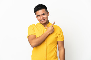 Young Ecuadorian man isolated on white background pointing to the side to present a product