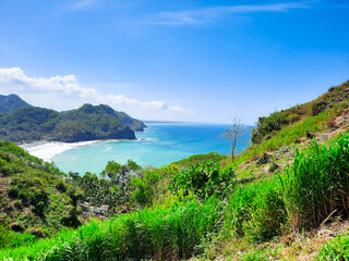 Surumanis beach, a beautiful blue beach with black sand and surrounded by hills