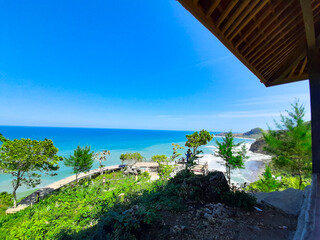 Surumanis beach, a beautiful blue beach with black sand and surrounded by hills