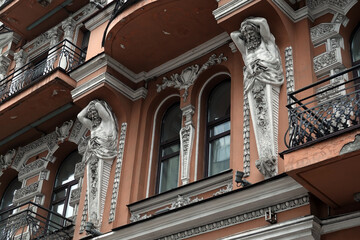Decoration of the facade of the building with sculptures and busts of Atlantes