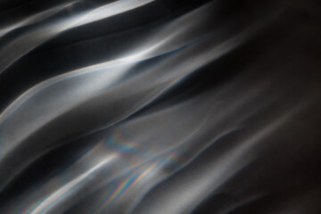 Abstract background, interference patterns formed by light. Picture of light on a black background, diagonal lines. Rainbow Mirage