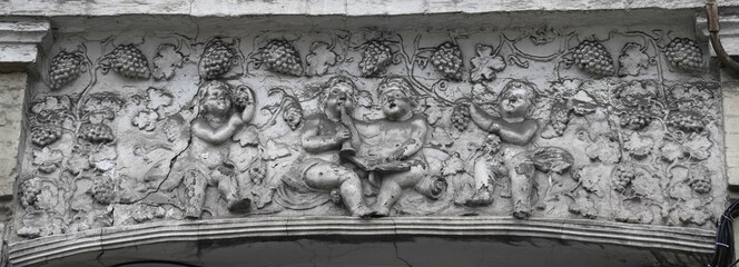 A bas-relief on the facade of a building with different subjects