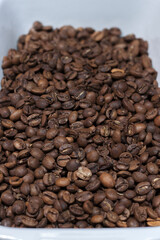 Perspective view of medium roasted coffee beans. Coffee shop. Freshly roasted coffee beans.