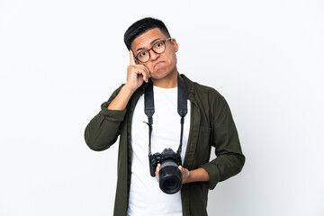 Young Ecuadorian photographer isolated on white background thinking an idea
