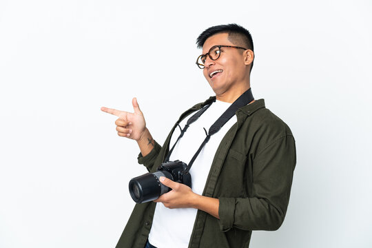 Young Ecuadorian photographer isolated on white background pointing finger to the side and presenting a product
