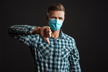 Serious grey-haired man wearing face mask