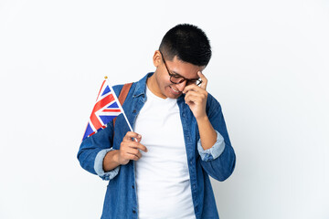 Young Ecuadorian woman holding an United Kingdom flag isolated on white background laughing