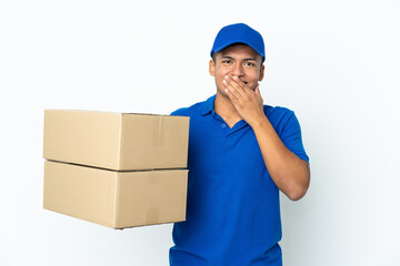 Delivery Ecuadorian man isolated on white background happy and smiling covering mouth with hand