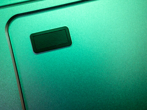fingerprint reader on laptop touchpad with green light, security theme