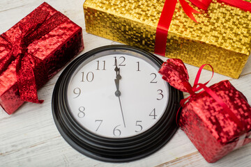 Time for gifts. Colorful gifts and a clock showing twelve.