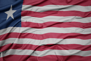 Obraz premium waving colorful national flag of liberia.