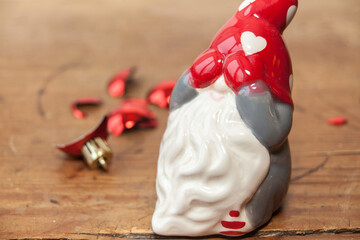 Santa clause decoration holding his mittens in front of his eyes