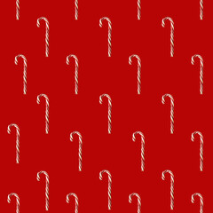Seamless pattern. Candy cane on a red background.