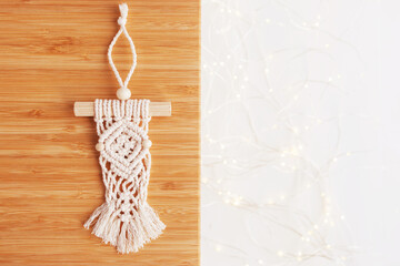 Christmas macrame decor. Christmas panel on wooden board. Natural materials - cotton thread, wood beads and stick. Eco decorations, ornaments, hand made decor. Winter and New Year holidays. Copy space