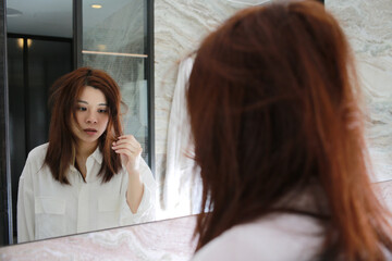 woman with decadent life face herself in the bathroom at morning