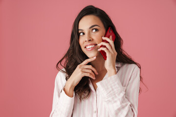 Fototapeta premium Cheerful beautiful woman smiling while talking on mobile phone