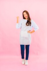 Portrait beautiful young asian woman in kitchen wear with apron