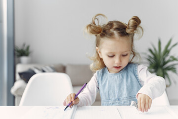 Naklejka premium Child with a books. Girl sitting on a table. Kid in a class.