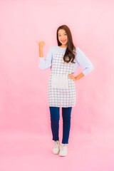 Portrait beautiful young asian woman in kitchen wear with apron