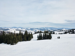 Beautiful natural landscape with mountains and bare trees covered with snow..Ski resort in winter season, Active recreation in the mountains. Isolation concept during quarantine.